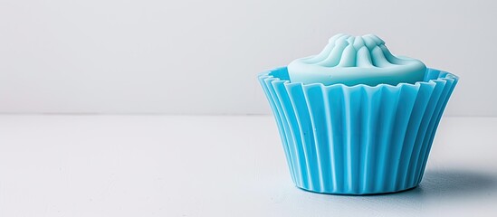 Poster - Silicone cupcake mold in blue against a white backdrop with copy space image.
