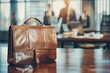 © gankevstock - Closeup of a leather briefcase on a conference table, with a blurred background of a business meeting in progress
