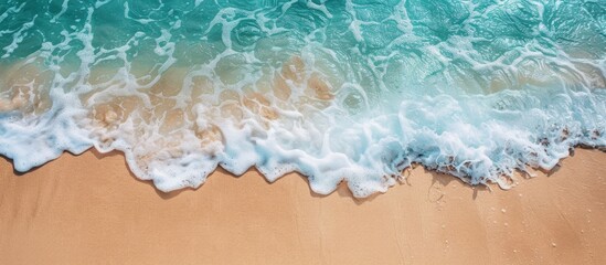 Leinwandbilder - Soothing ocean wave gently washing onto sandy shore, creating a serene summer backdrop with space for a text on a copy space image.