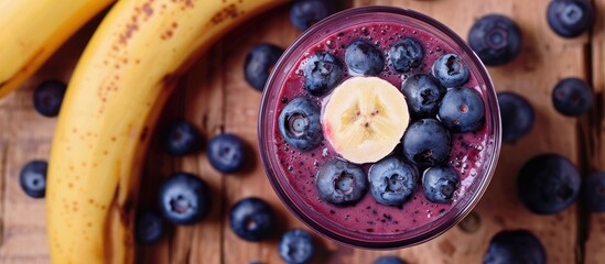 Wall Mural - Top view of a blueberry and banana smoothie in a glass jar, with a focus on healthy eating, copy space image included.