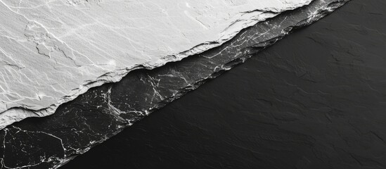 Poster - Combining black slate and white marble stone textures creates an elegant backdrop for a copy space image.