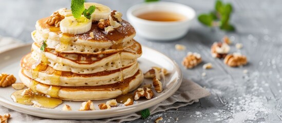 Poster - Walnut and banana pancakes displayed on a table with copy space image.