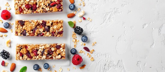 Aufkleber - Top view copy space image of four cereal granola bars with nuts and fruit berries on a white stone table, presenting a healthy and fitness-friendly dietary snack.