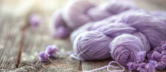 Poster - Engaging in knitting as a hobby with a background of a skein of pale lilac wool thread on a wooden table creates a serene and inviting atmosphere for a copy space image.