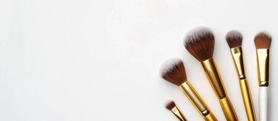 Poster - Golden makeup brushes for woman's beauty on a white background, featuring pastel colors with a copy space image.