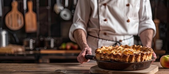 Sticker - A chef presents an apple pie on a kitchen spatula with a rustic background and ample copy space image.