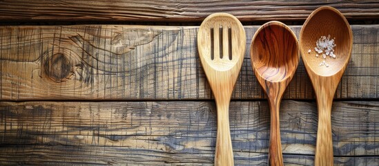 Poster - Wooden spoon and fork on a table with copy space image.