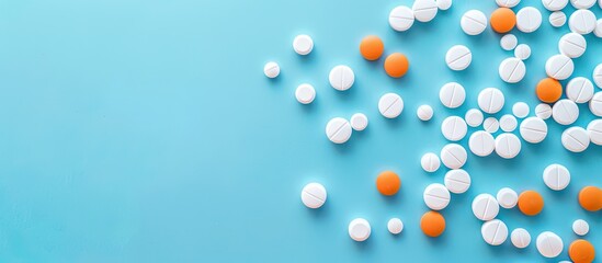 Aufkleber - Copy space image featuring white and orange pills against a blue backdrop.