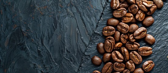 Aufkleber - Flatlay view of coffee beans arranged on a black stone background with copy space image.