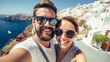 © Rafa Fernandez - Couple selfie with Santorini backdrop.