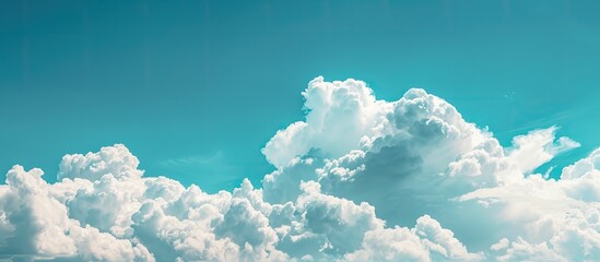 Wall Mural - Panoramic view of a sky with fluffy white clouds against a blue backdrop, ideal for copy space image.