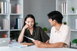 © itchaznong - Young Couple Discussing Investment Plans with Financial Planner in Modern Office Setting
