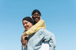 © EFStock - Two young Gen Z happy muslim women friends smiling under the sky