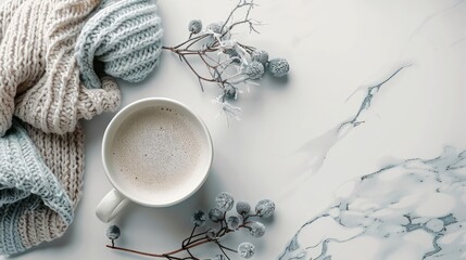 A mug of coffee sits on a table next to a blue and white knit blanket. Concept of warmth and comfort