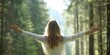 © Anastasiia - Young woman feeling free with outstretched arms in a forest, enjoying fresh air. Concept Nature Photography, Freedom, Female Empowerment, Lifestyle, Fresh Air