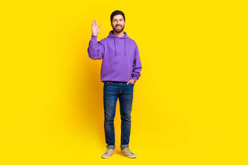 Sticker - Full body photo of attractive young man wave hand hello dressed stylish violet clothes isolated on yellow color background