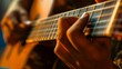© YURY YUTY - Closeup of fingers playing an acoustic guitar.