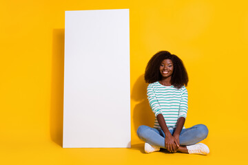 Wall Mural - Full length portrait of pretty positive person sitting floor near empty space telephone ui menu isolated on yellow color background