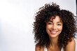 © Linggakun - Close-up of beautiful young woman in studio. Female with curly hair smiling at camera