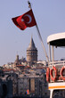 © Tatiana - Turkish flag, on a red background white star and moon. Turkish flag flies in the wind against the backdrop of Istanbul