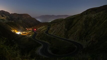 Wall Mural - night time lapse of a road winding through the mountains.