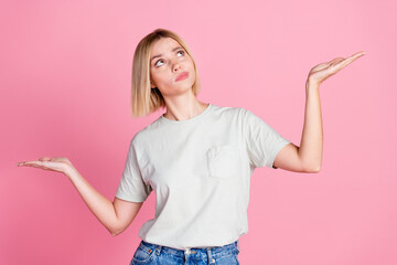 Sticker - Photo of minded woman with bob hairdo dressed gray t-shirt arms comparing objects look empty space isolated on pink color background