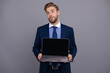 © be free - Businessman business man in suit showing laptop presenting office product isolated on grey