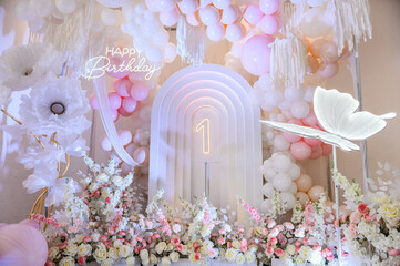 birthday party for 1 year old girl on a background photo wall. arch decoration pink, white balloons,