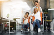 © Prostock-studio - Funny working time. Overjoyed millennial colleagues racing on office chairs in empty coworking space
