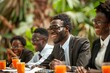 © Yuliia - Young African businessman with a well-groomed beard calculating finance bills with calculator, while others laugh and some wear eyeglasses.