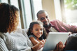 © ClearConcept/peopleimages.com - Man, woman and living room with child on tablet for learning, growth and development with online game. Family, girl and ebook in home for education, together on sofa with tech for multimedia website