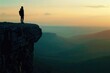 © darshika - Traveler alone on cliff admiring valley at sunset.