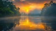 © NDmCX-Nic - Serene sunrise over a misty river surrounded by lush green trees, with vivid orange and yellow hues reflecting in the calm water.