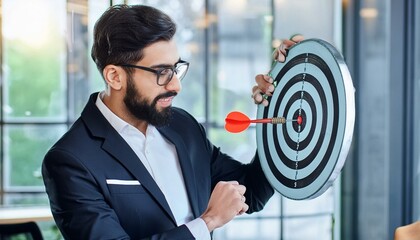 Businessman aims arrow at a virtual target dartboard, precision in setting objectives 