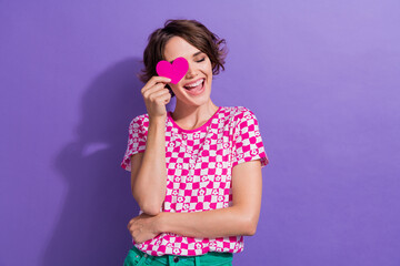 Poster - Photo portrait of attractive young woman heart cover eye laughing wear trendy pink clothes isolated on purple color background