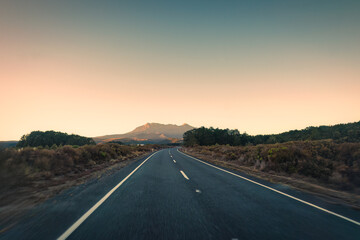 Wall Mural - Road trip with golden sunrise over volcanic mountain on wilderness