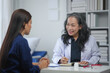 © amnaj - Doctor consulting with patient in a medical office, discussing health and wellness. Professional healthcare and medical advice concept.