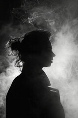 Poster - Silhouette of a person outlined by swirling smoke in a dark setting,