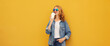 © rohappy - Modern stylish happy young woman drinking coffee posing on bright yellow background