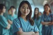 © Maxim Borbut - Having a chat with her team, dressed in scrubs, in the hospital