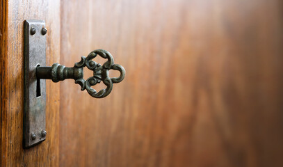 Fototapete - Old key in keyhole, macro shot. Gothic style. Key to knowledge. Concept and Idea for History, education, security, imprisonment, dungeon, prison background.