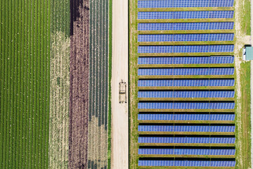 Aerial view of fields with country road farming lands and solar panel field in Southern California.