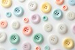 © Fotograf - A collection of variously colored buttons arranged on a plain white surface