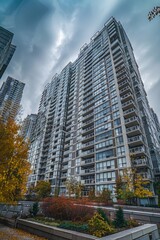 Poster - A modern skyscraper with numerous windows and a bustling city background