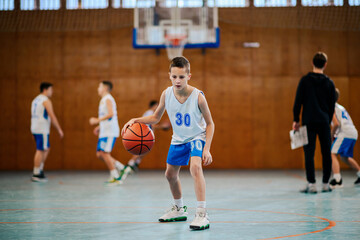 Wall Mural - Young athlete dribbling basketball