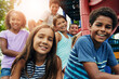 © Reese Coop/peopleimages.com - Portrait, friends and kids in park, smile and happiness with weekend break, outdoor and bonding together. Face, group and children with fun, recreation and sunshine with students, cheerful and joyful