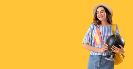 Poster - Young woman with flag of Spain, globe and backpack on yellow background