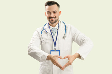 Canvas Print - Male doctor making heart with his hands on green background