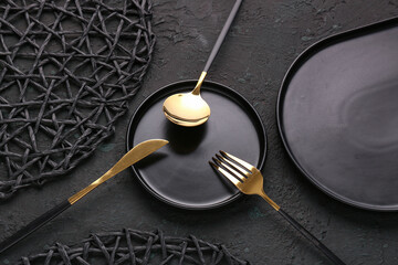 Wall Mural - Plate with golden cutlery on black background
