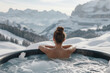 © Ivan - Young woman relaxing in bathtub or jacuzzi with hydromassage and bubbles with mountain view in winter with snow, back